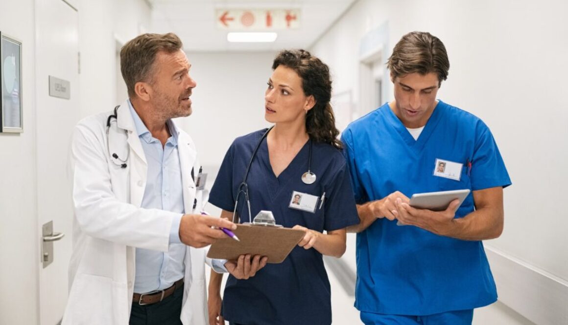 Doctor and nurses discussing patient case at hospital