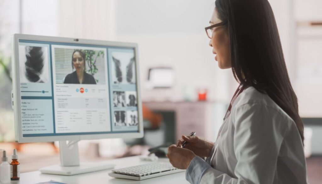 Hospital Medical Doctor Office: Portrait of Professional Female Physician Working on Desktop Computer, Talking to a Patient on a Internet Video Call Consultations, Writing Digital Prescriptions