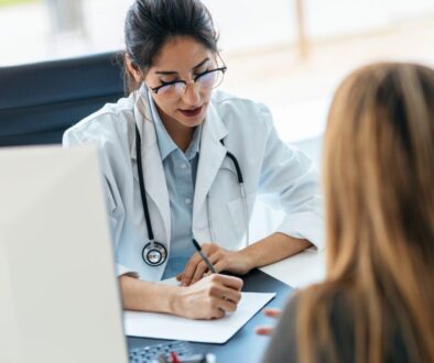 Beautiful cheerful female doctor talking while explaining medical treatment to patient in the consultation. Beautiful cheerful female doctor talking while explaining medical treatment to patient in the consultation.