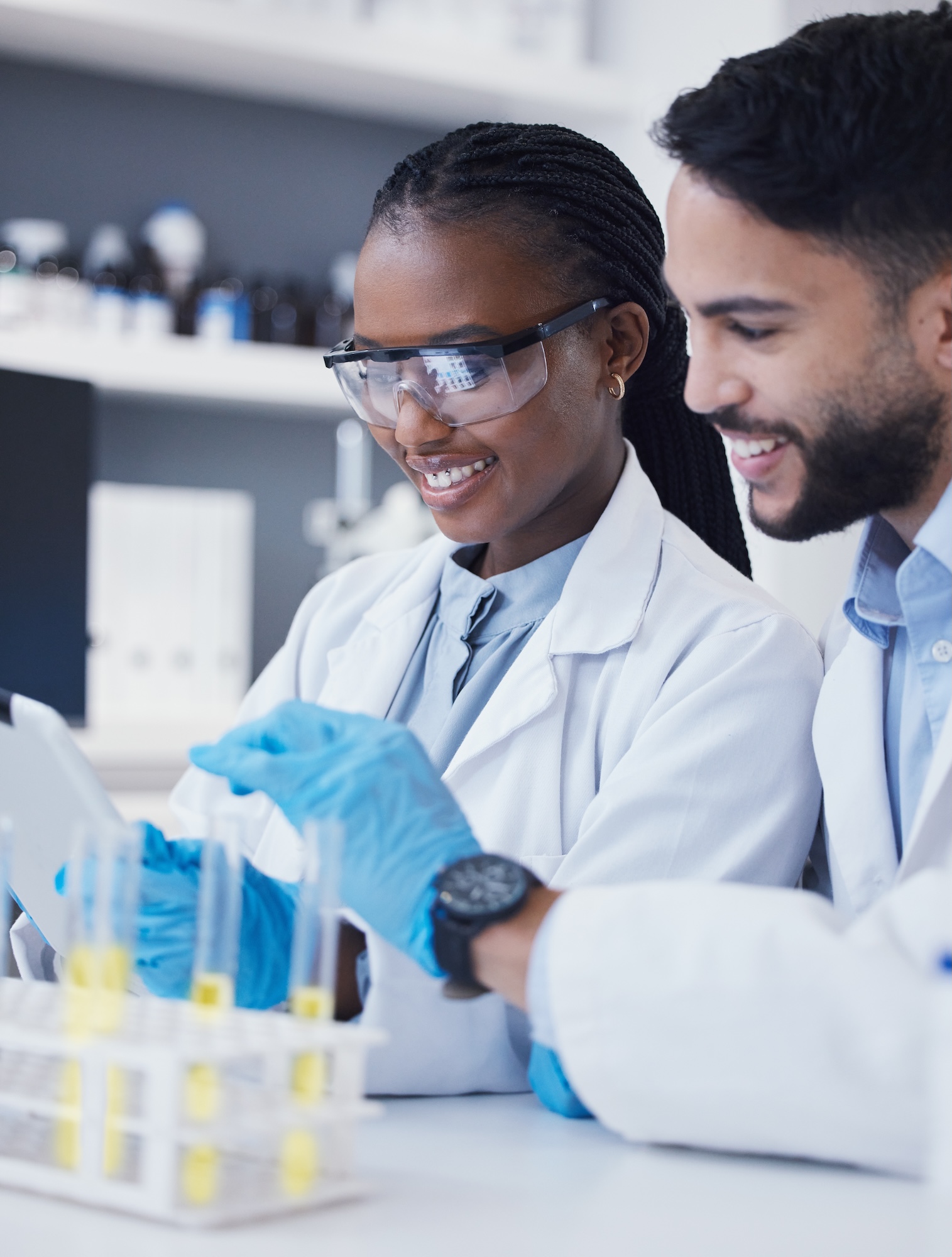 Test tube, laboratory and scientist people for medical research, vaccine solution and data analysis teamwork. Healthcare, science partner and happy woman with medicine or liquid inspection or check Test tube, laboratory and scientist people for medical research, vaccine solution and data analysis teamwork. Healthcare, science partner and happy woman with medicine or liquid inspection or check