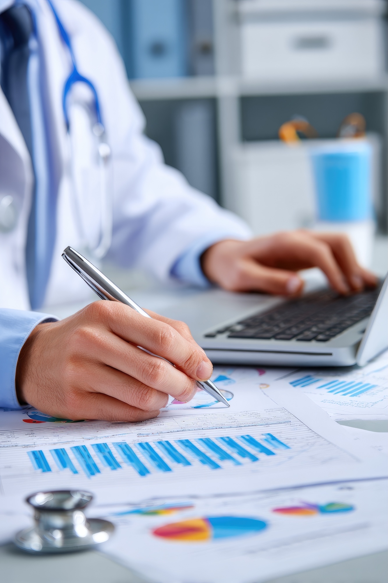 Doctor reviewing charts on laptop Doctor reviewing charts on laptop